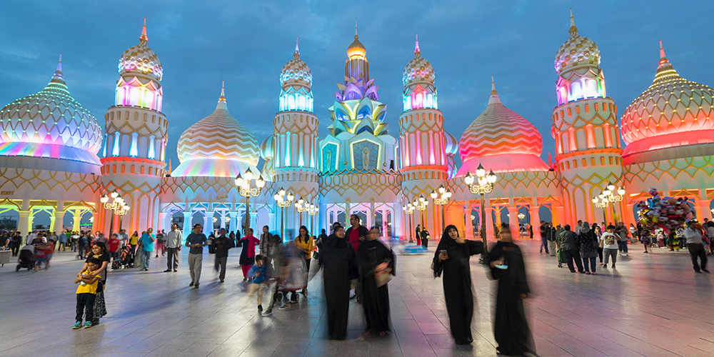F7CGKB Evening view of illuminated Gate of the World at Global Village 2015 in Dubai United Arab Emirates