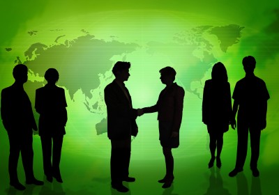 Business_People_In_Front_Of_A_Green_Map