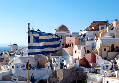 The flag of Greece - Houses of Oia as backdrop