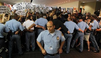 United Nations security personel form a cordon as protesting environmental activists attempt to gain access to the plenary session of the United Nations Climate Change Conference