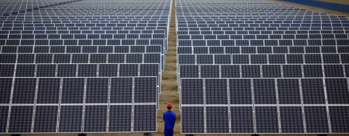 A worker inspects solar panels at a solar Dunhuang, 950km (590 miles) northwest of Lanzhou, Gansu Province September 16, 2013. China is pumping investment into wind power, which is more cost-competitive than solar energy and partly able to compete with coal and gas. China is the world's biggest producer of CO2 emissions, but is also the world's leading generator of renewable electricity. Environmental issues will be under the spotlight during a working group of the Intergovernmental Panel on Climate Change, which will meet in Stockholm from September 23-26. REUTERS/Carlos Barria (CHINA - Tags: ENERGY BUSINESS ENVIRONMENT) - RTX13UEF